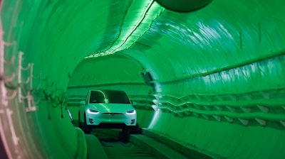 Elon Musk, co-founder and chief executive officer of Tesla Inc., arrives in a modified Tesla Model X electric vehicle during an unveiling event for the Boring Company Hawthorne test tunnel in Hawthorne, Calif., on Tuesday, Dec. 18, 2018. Musk unveiled his underground transportation tunnel on Tuesday, allowing reporters and invited guests to take some of the first rides in the revolutionary albeit bumpy subterranean tube — the tech entrepreneur's answer to what he calls 'soul-destroying traffic.'