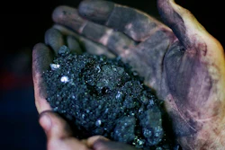 In this Oct. 6, 2015, file photo, Superintendent Jackie Ratliff, a coal miner, holds coal running through a processing plant in Welch, W.Va. A federal report says Americans are using less coal this year than at any time since Jimmy Carter's presidency despite the Trump administration's efforts to revive the country's coal industry. Energy Secretary Rick Perry on Tuesday urged development of Appalachian coal country’s natural gas and petrochemical sectors.