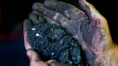 In this Oct. 6, 2015, file photo, Superintendent Jackie Ratliff, a coal miner, holds coal running through a processing plant in Welch, W.Va. A federal report says Americans are using less coal this year than at any time since Jimmy Carter's presidency despite the Trump administration's efforts to revive the country's coal industry. Energy Secretary Rick Perry on Tuesday urged development of Appalachian coal country’s natural gas and petrochemical sectors.