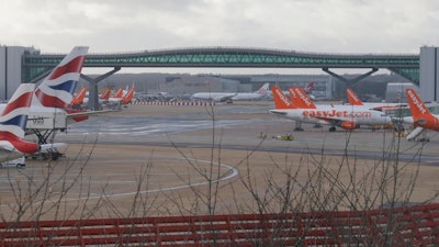 Planes are grounded at Gatwick airport, near London, as the airport remains closed with incoming flights delayed or diverted to other airports, after drones were spotted over the airfield last night and this morning, Thursday, Dec. 20, 2018. London's Gatwick Airport remained shut during the busy holiday period Thursday while police and airport officials investigate reports that drones were flying in the area of the airfield.