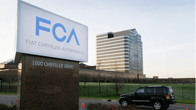 In this May 6, 2014, file photo, a vehicle moves past a sign outside Fiat Chrysler Automobiles world headquarters in Auburn Hills, Mich. Fiat Chrysler will open another assembly plant in the Detroit area, according to a person familiar with the automaker's plan. The source said the plant will produce SUVs but did not specify when it will open or how many jobs it will create. The person spoke on condition of anonymity because the plan has not been made public. Fiat Chrysler declined to comment Thursday, Dec. 6, 2018.