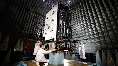 This March 22, 2016, photo provided by Lockheed Martin shows the first GPS III satellite inside the anechoic test facility at Lockheed Martin's complex south of Denver. The facility is used to ensure the signals from the satellite's components and payload will not interfere with each other. The satellite is scheduled to be launched from Cape Canaveral, Fla., on Tuesday, Dec. 18, 2018.