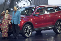 Malaysia Prime Minister Mahathir Mohamad, right, poses with his wife Siti Hasmah during the launch of Proton's new SUV.