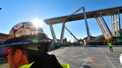 A view of the opening of the construction sites for the demolition of the collapsed Morandi highway bridge in Genoa, northern Italy, Saturday, Dec. 15, 2018. Genoa's mayor is promising his city will have a new bridge by Christmas 2019 to replace the one that collapsed, killing 43 people.