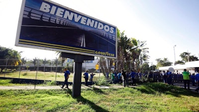 A Goodyear billboard emblazoned with the Spanish word for welcome, is posted near a plant entrance company where workers arrived to find the plant is no longer in operation, in Los Guayabos, Venezuela, Monday, Dec. 10, 2018. U.S. tire company Goodyear announced it will no longer continue production in Venezuela as economic conditions in the South American nation continue to deteriorate.