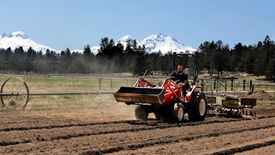 In this April 23, 2018 file photo, Trevor Eubanks, plant manager for Big Top Farms, readies a field for another hemp crop near Sisters, Oregon. Hemp is about to get the federal legalization that marijuana, its cannabis cousin, craves. That unshackling at the national level sets the stage for greater expansion in an industry seeing explosive growth through demand for CBDs, the non-psychoactive compound in hemp that many see as a way to better health.