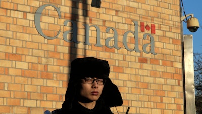 A policeman stands watch outside the Canadian Embassy in Beijing.