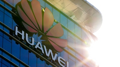 The logo of Huawei stands on its office building at the research and development centre in Dongguan in south China's Guangdong province, Tuesday, Dec. 18, 2018. While a top executive of Chinese tech giant Huawei faces possible U.S. charges over trade with Iran, the company's goal to be a leader in next-generation telecoms is colliding with security worries abroad. Australia and New Zealand have barred Huawei as a supplier for fifth-generation networks, joining the U.S. and Taiwan. Last week, Japan's cybersecurity agency said Huawei and other vendors deemed risky will be off-limits for government purchases.