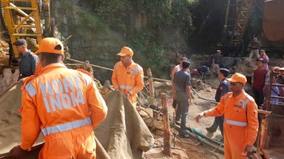 Rescuers work at the site of a coal mine that collapsed in Ksan, in the northeastern Indian state of Meghalaya, Friday, Dec. 14, 2018. Thirteen young miners were missing and feared dead following the collapse of a shaft and flooding of a coal mine they were digging illegally in India's remote northeast, police said Friday.