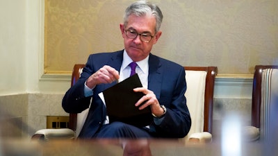 In this Thursday, Nov. 29, 2018, file photo Federal Reserve Chairman Jerome Powell waits to address the Federal Reserve Board's 15th annual College Fed Challenge Finals in Washington. The Federal Reserve says that the U.S. economy was growing in the fall, but there were concerns about higher tariffs from a widening trade war, rising interest rates and tight labor markets. In its latest report on economic conditions around the country, the Fed says most of its 12 regions saw moderate growth through late November. Dallas and Philadelphia says growth had slowed while St. Louis and Kansas City depicted growth as slight.