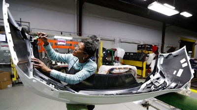 In this Nov. 28, 2018, file photo final inspector Mary Skinner inspects the rear end of a General Motors Chevrolet Cruze at Jamestown Industries in Youngstown, Ohio. On Monday, Dec. 3, the Institute for Supply Management, a trade group of purchasing managers, issues its index of manufacturing activity for November.