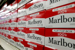 his June 14, 2018, file photo shows cartons of Marlboro cigarettes on the shelves at JR outlet in Burlington, N.C. Curiosity from one the world's largest tobacco companies about the marijuana business sent shares of a Canadian cannabis company higher at the opening bell Tuesday, Dec. 4. Cronos Group confirmed talks late Monday with Marlboro maker Altria about a possible investment.