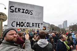 A demonstrator holds a placard during a 'Claim the Climate' march in Brussels.