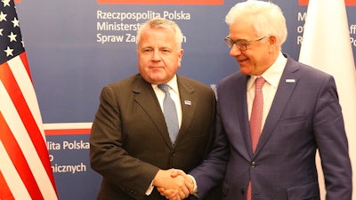 U.S. deputy secretary of state, John Sullivan, right, shakes hands with Polish Foreign Minister Jacek Czaputowicz in Warsaw, Poland, Wednesday, Dec. 19, 2018.The meeting comes as part of a tour by Sullivan to the region. The State Department said ahead of the visit that the reason for his visit to Poland was to reaffirm the U.S. commitment to NATO and commend Poland for its contributions to the alliance's common defense and its efforts to advance energy security.