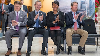 Commissioner of the Georgia Department of Economic Development Pat Wilson, from left, Norfolk Southern CEO Jim Squires, Atlanta Mayor Keisha Lance Bottoms and Georgia Governor-Elect Brian Kemp react to a speaker during a press conference in the Georgia State Capitol building in Atlanta. During the presser, Fortune 500 company Norfolk Southern officially announced that they will be moving their headquarters to Atlanta.