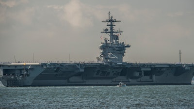In this 2013 photo, the nuclear-powered aircraft carrier USS Theodore Roosevelt (CVN 71) returns to homeport.