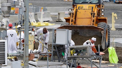 In this March 6, 2013 file photo, workers are shown at the 'C' Tank Farm at the Hanford Nuclear Reservation, near Richland, Wash. Conservation groups are alarmed by the Trump administration's proposal to rename some radioactive waste left from the production of nuclear weapons to make it cheaper and easier to achieve permanent disposal. The U.S. Department of Energy is considering a change in its legal definition of high-level radioactive waste, which is stored at places like the Hanford.