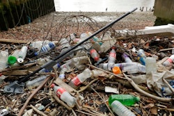 In this Feb. 5, 2018 file photo, plastic bottles and other plastics including a mop, lie washed up on the north bank of the River Thames in London. European Union officials agreed on Wednesday, Dec. 19, 2018, to ban some single-use plastics, such as disposable cutlery, plates and straws, in an effort to cut marine pollution. The measure will also affect plastic cotton buds, drink stirrers, balloon sticks, and single-use plastic and polystyrene food and beverage containers.