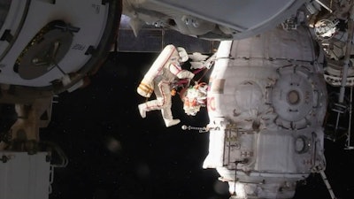 In this image from video made available by NASA, Russian cosmonaut Oleg Kononenko performs a spacewalk outside the International Space Station.