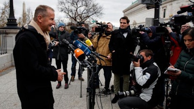 Volkswagen Group CEO Herbert Diess talks with reporters after meeting with President Donald Trump at the White House, Tuesday, Dec. 4, 2018, in Washington.