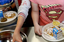 In this 2017 file photo, students line up for lunch at a middle school in Sandy, Utah. The U.S. Department of Agriculture recently announced the scaling back of contested school lunch standards implemented under the Obama administration.
