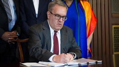 Acting EPA Administrator Andrew Wheeler signs an order withdrawing an Obama era emissions standards policy, at the EPA Headquarters in Washington, Thursday, Dec. 6, 2018.