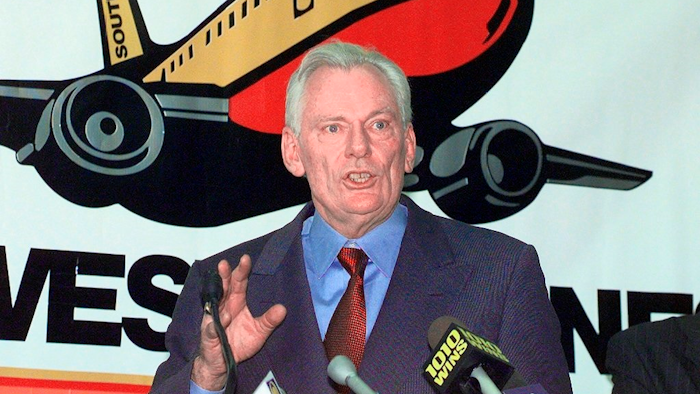 In this Dec. 9, 1998, file photo, Southwest Airlines President and CEO Herb Kelleher speaks at a news conference at MacArthur Airport in Islip, N.Y. Not many CEOs dress up as Elvis Presley, settle a business dispute with an arm-wrestling contest, or go on TV wearing a paper bag over their head. Southwest confirmed Kelleher died on Thursday, Jan. 3, 2019. He was 87.