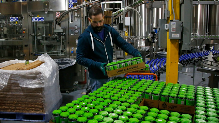 Josh Yager transfers cans of F5, one of their most popular brews, from the production line at COOP Ale Works in Oklahoma City, Friday, Jan. 18, 2019. Rules that went into effect in Oklahoma in October allow grocery, convenience and retail liquor stores to sell chilled beer with an alcohol content of up to 8.99 percent. Previously, grocery and convenience stores could offer only 3.2 percent beer. Liquor stores, where stronger beers were available, were prohibited from selling it cold.