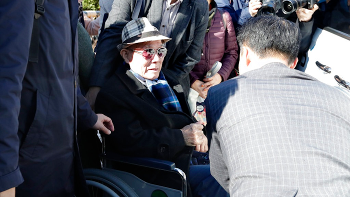 In this Oct. 30, 2018, file photo, South Korean Lee Chun-sik, 94-year-old victim of forced labor during Japan's colonial rule of the Korean Peninsula before the end of World War II, sits on a wheelchair upon his arrival at the Supreme Court in Seoul, South Korea. Lawyers for South Koreans forced into wartime labor have taken legal steps to seize the South Korean assets of a Japanese company they are trying to pressure into following a court ruling to provide them compensation.