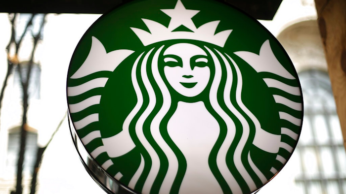 This Saturday, March 24, 2018, file photo, shows a sign at a Starbucks in the U.S. Starbucks is expanding its delivery service and aims to offer it at nearly one-fourth of its U.S. company-operated coffee shops.