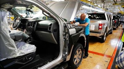 In this Sept. 27, 2018, file photo a United Auto Workers assemblyman works on a 2018 Ford F-150 truck being assembled at the Ford Rouge assembly plant in Dearborn, Mich. On Friday, Jan. 18, 2019, the Federal Reserve reports on U.S. industrial production for December.