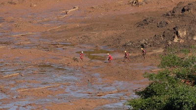Rescue workers look for victims in the mud at a site where a hotel used to be, days after a dam collapse in Brumadinho, Brazil.