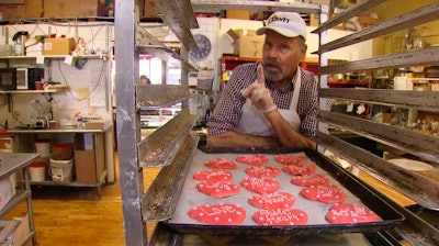 Baker Ken Bellingham, who owns Edmonds Bakery, speaks during an interview at his shop in Edmonds, Washington. Bellingham is apologizing for a politically charged Valentine's Day cookie that generated an uproar on social media.