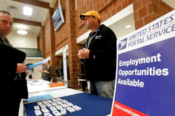 In this Nov. 2, 2017, file photo a recruiter from the postal service, right, speaks with an attendee of a job fair in the cafeteria of Deer Lakes High School in Cheswick, Pa. Even with fear of a global economic slump depressing stock markets, Friday, Jan. 4, 2019 jobs report for December is expected to offer reassurance that the U.S. economy remains sturdy and on track to expand for a 10th straight year.