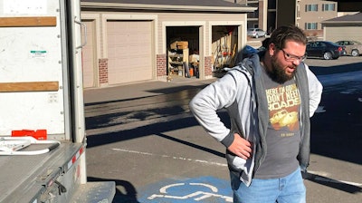 George Jankowski, a furloughed U.S. Department of Agriculture worker, helps a friend move out of an apartment in Cheyenne, Wyo., Monday, Jan. 14, 2019. Jankowski was paid $30 for his help. Many federal workers are doing odd jobs or driving for ride-hailing apps to help make ends meet during the partial federal government shutdown.