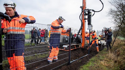 Workers erect a fence along the Denmark Germany border. Denmark has begun erecting a fence along the German border to keep out wild boars in an attempt to prevent the spread of African swine fever.