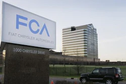 In this May 6, 2014, file photo, a vehicle moves past a sign outside Fiat Chrysler Automobiles world headquarters in Auburn Hills, Mich. Fiat Chrysler will pay more than $650 million to settle allegations that it cheated on emissions tests involving more than 104,000 Jeep SUVs and Ram pickup trucks, a person with the knowledge of the settlement told The Associated Press on Wednesday, Jan. 9, 2019.