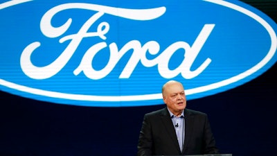 In this Jan. 14, 2018, file photo Ford President and CEO Jim Hackett prepares to address the media at the North American International Auto Show in Detroit. A new version of the Ford Explorer big SUV will be shown off at the auto show starting Monday, Jan. 14, 2019, and it will have an optional hybrid power system. It is Ford’s first hybrid SUV in six years, and the company also has plans for a fully electric SUV based on the Mustang sometime next year. Seven battery-powered vehicles are planned for the U.S. by 2022, even a hybrid pickup truck.