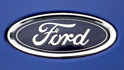 In this Tuesday, Aug. 22, 2017 file photo, a Ford emblem is seen on a car at a store in London. Ford Motor Co. says it is cutting jobs in Europe in a wide-ranging restructuring as it focuses on its most profitable models and shifts production towards electric cars. In a statement, the company said Thursday, Jan. 10, 2019 that 'structural cost improvements will be supported by a reduction of surplus labor,' both hourly and salaried.