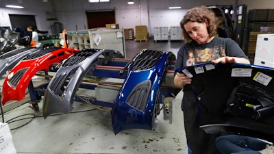 n this Nov. 28, 2018, file photo Crystal Odum inspects the front end of a General Motors Chevrolet Cruze at Jamestown Industries in Youngstown, Ohio. On Thursday, Jan. 3, 2019, the Institute for Supply Management, a trade group of purchasing managers, issues its index of manufacturing activity for December.
