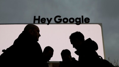 People stand in front of the Google tent during preparations for CES International, Saturday, Jan. 5, 2019, in Las Vegas.