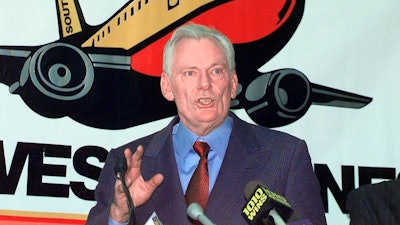 In this Dec. 9, 1998, file photo, Southwest Airlines President and CEO Herb Kelleher speaks at a news conference at MacArthur Airport in Islip, N.Y. Not many CEOs dress up as Elvis Presley, settle a business dispute with an arm-wrestling contest, or go on TV wearing a paper bag over their head. Southwest confirmed Kelleher died on Thursday, Jan. 3, 2019. He was 87.