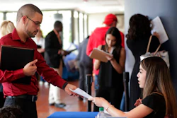 In this Jan. 30, 2018, file photo, an employee of Aldi, right, takes an application from a job applicant at a JobNewsUSA job fair in Miami Lakes, Fla. On Thursday, Jan. 3, 2019, payroll processor ADP reports how many jobs private employers added in December.