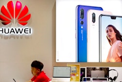 In this July 4, 2018, file photo, a sales clerk looks at his smartphone in a Huawei store at a shopping mall in Beijing. China has called on the United States to ‘stop the unreasonable crackdown’ on Huawei following the tech giant’s indictment on charges of stealing technology, violating trade sanctions and lying to banks.