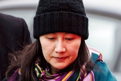 In this Dec. 12, 2018, file photo, Huawei chief financial officer Meng Wanzhou arrives at a parole office with a security guard in Vancouver, British Columbia. China on Tuesday, Jan. 22, 2019, demanded the U.S. drop a request that Canada extradite the top executive of the tech giant Huawei, shifting blame to Washington in a case that has severely damaged Beijing’s relations with Ottawa.