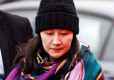 In this Dec. 12, 2018, file photo, Huawei chief financial officer Meng Wanzhou arrives at a parole office with a security guard in Vancouver, British Columbia. China on Tuesday, Jan. 22, 2019, demanded the U.S. drop a request that Canada extradite the top executive of the tech giant Huawei, shifting blame to Washington in a case that has severely damaged Beijing’s relations with Ottawa.