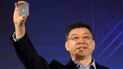 William Xu, director, chief strategy marketing officer, chairman of the Investment Review Board of Huawei, displays a processor chip during an unveiling ceremony in Shenzhen, China, Monday, Jan. 7, 2019. Chinese telecom giant Huawei unveiled a processor chip for data centers and cloud computing as it expands into an emerging global market despite Western warnings the company might be a security risk.