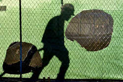 In this Nov. 14, 2018 file photo, the shadow of a worker falls on a fence at the construction site of a convenience store in Victorville, Calif. On Wednesday, Jan. 16, 2019, the Federal Reserve releases its latest 'Beige Book' survey of economic conditions. The Beige Book is based on anecdotal reports from businesses and will be considered along with other data when Fed policymakers meet next.