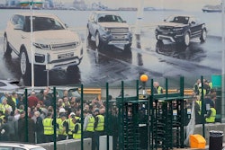 Staff gather inside the gates of the Jaguar Land Rover site in Halewood near Liverpool, England, Thursday Jan. 10, 2019. According to media reports, Jaguar Land Rover is widely expected to announce up to 5,000 job cuts as the carmaker addresses slowing demand in China and growing uncertainty about the U.K.'s Brexit departure from the European Union.
