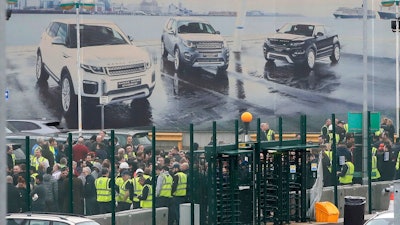 Staff gather inside the gates of the Jaguar Land Rover site in Halewood near Liverpool, England, Thursday Jan. 10, 2019. According to media reports, Jaguar Land Rover is widely expected to announce up to 5,000 job cuts as the carmaker addresses slowing demand in China and growing uncertainty about the U.K.'s Brexit departure from the European Union.